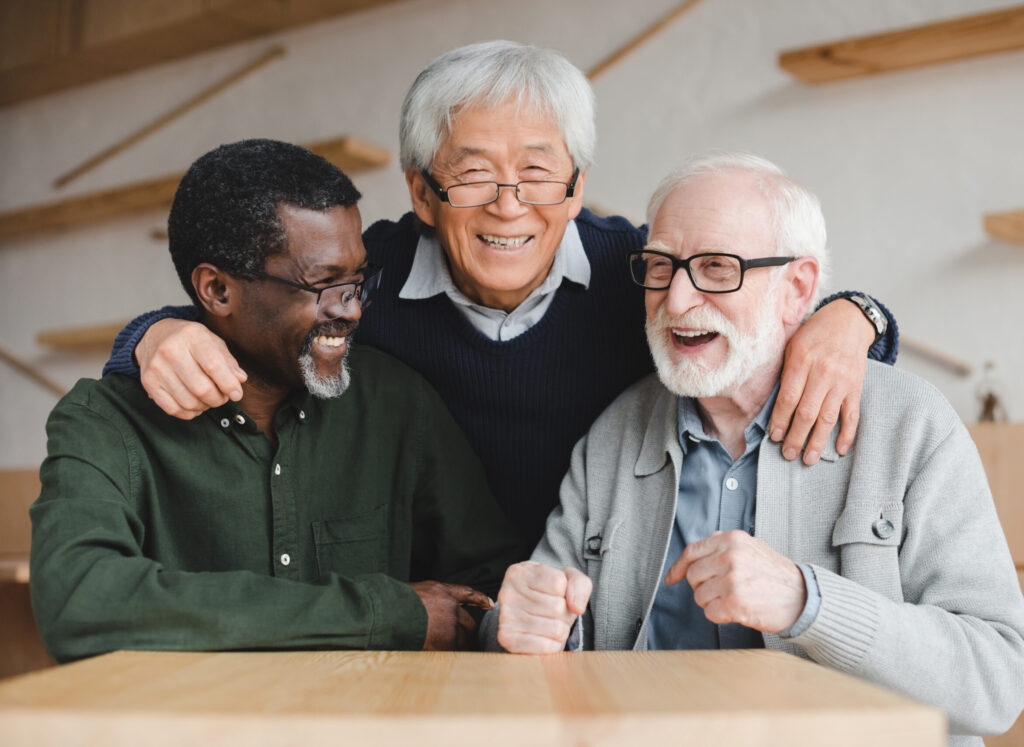 A group of three smiling elderly men